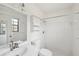 All-white bathroom with sink, tiled shower, medicine cabinet, and window at 5414 Ansonia Ter, North Port, FL 34287