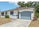 Home featuring attached garage, concrete driveway, and an arch over the garage door at 5414 Ansonia Ter, North Port, FL 34287