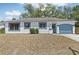 Charming single-story home with blue trim, attached garage, and a cozy front yard at 5414 Ansonia Ter, North Port, FL 34287