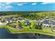 Aerial view of neighborhood homes with lake, pool and recreation areas, surrounded by green spaces at 5583 Summit Gln, Bradenton, FL 34203