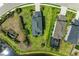 Aerial view of a house with a well-maintained lawn, landscaping, and a nearby lake at 5583 Summit Gln, Bradenton, FL 34203