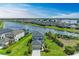 Aerial view of a house with a well-manicured lawn, landscaping, and a lake in the background at 5583 Summit Gln, Bradenton, FL 34203