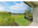 Backyard features a tranquil lake view, well-maintained lawn, and a charming fire pit, great for entertaining at 5583 Summit Gln, Bradenton, FL 34203