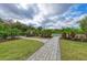Community basketball court with paved pathway, landscaping and nearby seating at 5583 Summit Gln, Bradenton, FL 34203