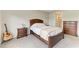 Inviting bedroom boasts a wooden bed, plush carpet, and neutral tones, creating a relaxing atmosphere at 5583 Summit Gln, Bradenton, FL 34203