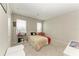 Simple bedroom with neutral color scheme and large window at 5583 Summit Gln, Bradenton, FL 34203