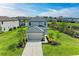 Two-story home with well-maintained lawn, garden beds and a driveway with mature palm trees at 5583 Summit Gln, Bradenton, FL 34203