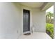 Covered front porch with black door and angel statue at 5583 Summit Gln, Bradenton, FL 34203
