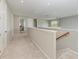 Upstairs hallway featuring neutral carpeting, recessed lighting, and access to the various bedrooms and bathrooms at 5583 Summit Gln, Bradenton, FL 34203