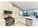 Bright kitchen boasts modern appliances and transitions into the living area at 5583 Summit Gln, Bradenton, FL 34203