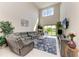 Cozy living room features a large sectional sofa, stylish rug, and ample natural light at 5583 Summit Gln, Bradenton, FL 34203