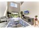 Spacious living room features a modern sectional sofa, tile flooring and a patio view at 5583 Summit Gln, Bradenton, FL 34203