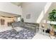 Spacious living room features tile flooring, and a large sectional sofa with views of the kitchen at 5583 Summit Gln, Bradenton, FL 34203
