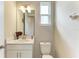 Clean half bathroom features a single sink vanity with storage and a well-lit mirror above the toilet at 5583 Summit Gln, Bradenton, FL 34203