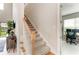 Carpeted staircase with a wooden handrail leads to the upper level, adjacent to the naturally lit office space at 5583 Summit Gln, Bradenton, FL 34203