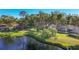 Backyard view featuring a peaceful pond and green landscaping, creating a serene outdoor space at 5711 Garden Lakes Fern, Bradenton, FL 34203