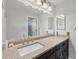 Bathroom vanity features granite counters, updated fixtures, and a large mirror at 5711 Garden Lakes Fern, Bradenton, FL 34203