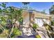 Charming single-story home featuring a brick accent, green front door, and a well-maintained walkway at 5711 Garden Lakes Fern, Bradenton, FL 34203
