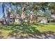Charming single-story home featuring mature trees, lush lawn, and well-maintained landscaping at 5711 Garden Lakes Fern, Bradenton, FL 34203