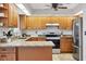 Bright kitchen featuring granite countertops, stainless steel appliances, and neutral color palette at 5711 Garden Lakes Fern, Bradenton, FL 34203