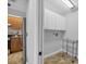 Well-lit laundry area next to kitchen, features white cabinetry and tiled floors at 5711 Garden Lakes Fern, Bradenton, FL 34203