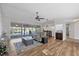 Open-concept living room with hardwood floors, large windows, and a view of the screened in patio at 5711 Garden Lakes Fern, Bradenton, FL 34203