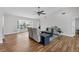 Bright living room features wood floors, ceiling fan, large window with view, and neutral decor at 5711 Garden Lakes Fern, Bradenton, FL 34203