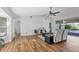 Bright living room featuring vaulted ceilings, wood flooring, and views of the backyard patio at 5711 Garden Lakes Fern, Bradenton, FL 34203