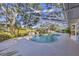 Large screened pool with a sun deck and beautiful landscaping at 5711 Garden Lakes Fern, Bradenton, FL 34203