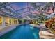 Screened pool with lush landscaping and covered patio for outdoor enjoyment at 5711 Garden Lakes Fern, Bradenton, FL 34203