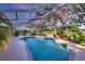 An inviting screened-in pool surrounded by landscaping, offering a private backyard retreat for relaxation at 5711 Garden Lakes Fern, Bradenton, FL 34203