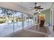 Bright sun room features floor-to-ceiling windows with views of the sparkling pool and backyard at 5711 Garden Lakes Fern, Bradenton, FL 34203