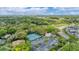Aerial view of tennis courts in residential area with lush greenery and landscaping at 5711 Garden Lakes Fern, Bradenton, FL 34203