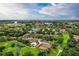 Stunning aerial view showcasing the community, with lush greenery, a pool, and a well-maintained golf course at 6040 Oak Creek Ln # 1822, Bradenton, FL 34210