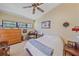 Bedroom with a ceiling fan, dresser and desk at 6040 Oak Creek Ln # 1822, Bradenton, FL 34210