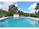 Sparkling blue pool with a pool house and comfortable lounge chairs for relaxation at 6040 Oak Creek Ln # 1822, Bradenton, FL 34210