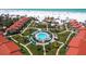 Breathtaking aerial view of community pool, white sand beach, and resort-style amenities at 6204 Midnight Pass Rd # 102, Sarasota, FL 34242