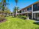 Beautiful condominium backyard, featuring a well-maintained lawn and lush landscaping at 6204 Midnight Pass Rd # 102, Sarasota, FL 34242