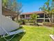 Spacious backyard featuring mature landscaping with a white lounge chair for relaxation at 6204 Midnight Pass Rd # 102, Sarasota, FL 34242