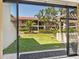 View of the lush backyard with mature landscaping and shade trees from the sliding glass doors at 6204 Midnight Pass Rd # 102, Sarasota, FL 34242