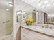 Well-lit bathroom featuring a glass shower and a white vanity with countertop space and neutral wall color at 6204 Midnight Pass Rd # 102, Sarasota, FL 34242