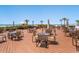 Expansive outdoor deck with tables and seating, perfect for enjoying beachside dining and ocean views at 6204 Midnight Pass Rd # 102, Sarasota, FL 34242