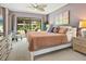 Cozy bedroom with a king size bed and sliding door to a patio with outside seating at 6204 Midnight Pass Rd # 102, Sarasota, FL 34242