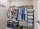 Organized closet with shelving, hanging racks, and storage trunk, maximizing space and functionality at 6204 Midnight Pass Rd # 102, Sarasota, FL 34242