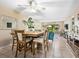 Open-concept dining area featuring neutral tones, ceiling fan, and sliding glass doors for seamless indoor-outdoor living at 6204 Midnight Pass Rd # 102, Sarasota, FL 34242