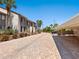 Paver driveway leads to condo units; features carport and tropical foliage at 6204 Midnight Pass Rd # 102, Sarasota, FL 34242