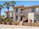 Charming two-story condo with private entrance, lush landscaping, and brick paver walkway at 6204 Midnight Pass Rd # 102, Sarasota, FL 34242