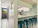 View of the updated kitchen with a breakfast bar, attractive backsplash, and modern finishes at 6204 Midnight Pass Rd # 102, Sarasota, FL 34242