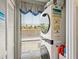 Laundry area featuring a stacked washer and dryer with natural light at 6204 Midnight Pass Rd # 102, Sarasota, FL 34242