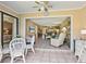 View of the open floor plan into the living room and dining area from the enclosed lanai at 6204 Midnight Pass Rd # 102, Sarasota, FL 34242